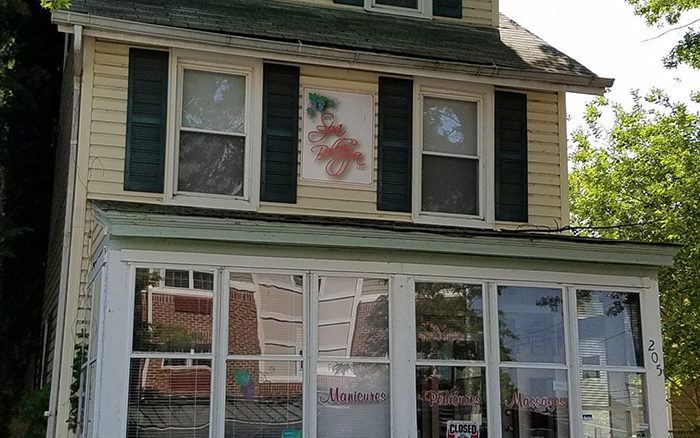 House front with a spa logo sign