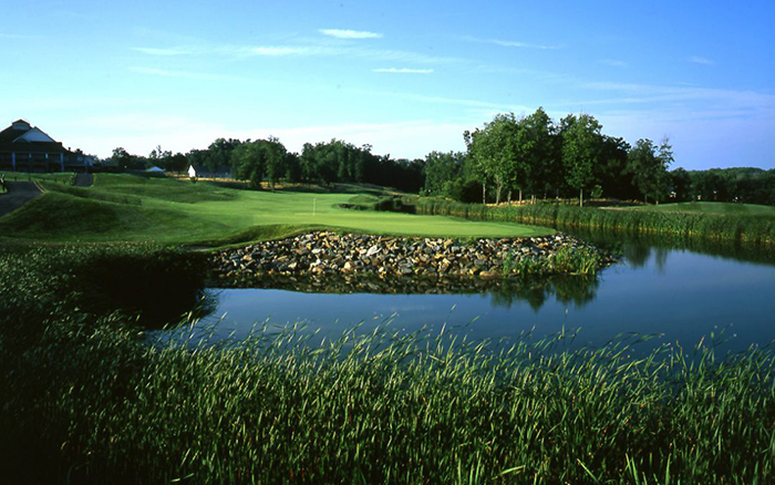 View of serene golf course with pond.