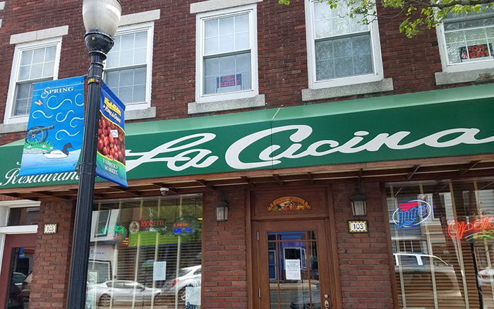 Italian restaurant brick front with green awning.