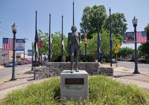 statue of Marquis de Lafayette in town square surrounded by flags